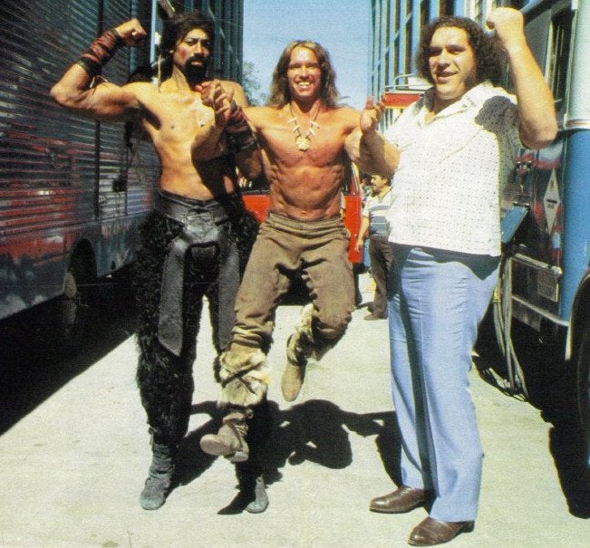 Wilt Chamberlain (7'1) and Andre the Giant (7'4) with Arnold Schwarzenegger (6'0" or 6'1") 