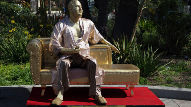 Golden Harvey Weinstein street art in Hollywood, Los Angeles, USA Casting couch in Hollywood, Harvey Weinstein's Casting Couch statue